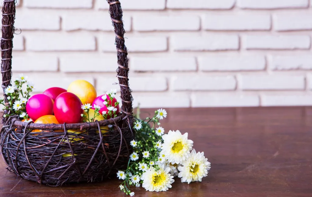 colorful-easter-eggs-brown-basket-with-flower_1232-1839.jpg