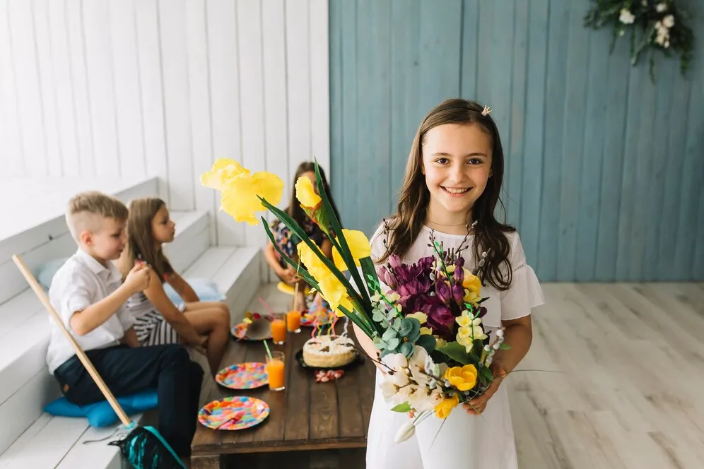 cheerful-girl-with-bouquet-birthday-party_23-2147897710.jpg