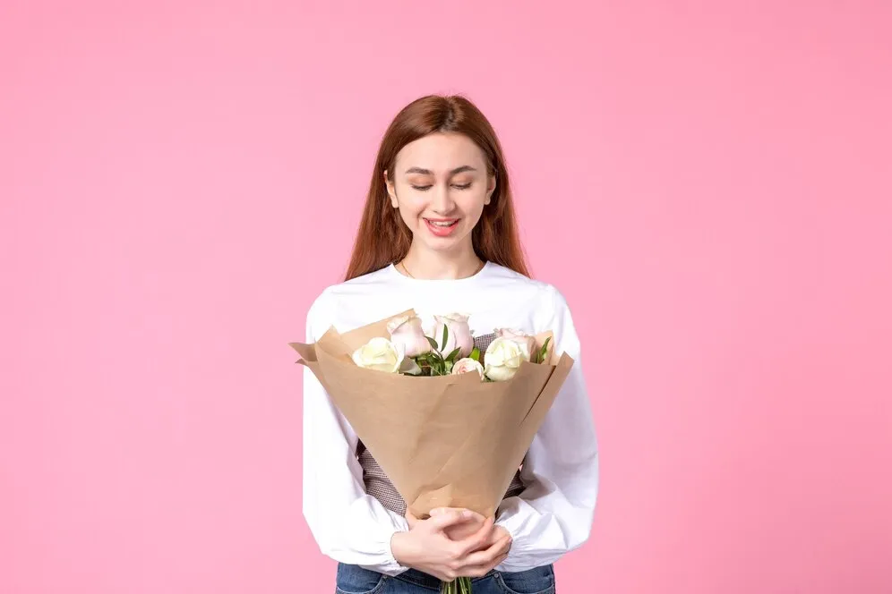 front-view-young-female-holding-bouquet-beautiful-roses-pink_140725-147092.jpg